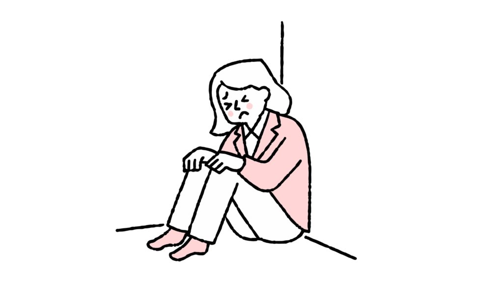 部屋の隅で膝を抱えて座り込み、辛そうな表情をしている女性のイラスト